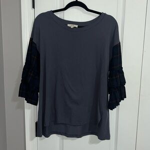 Cure blue blouse with patterned sleeves.
